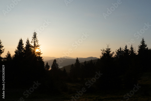 Sunrise  In The Mountains With Silhouettes Of Peaks In The Rays Of The Setting Sun, Scenic Mountain Landscape In Yellow Red And Pink Hues, Evening Nature Background	
