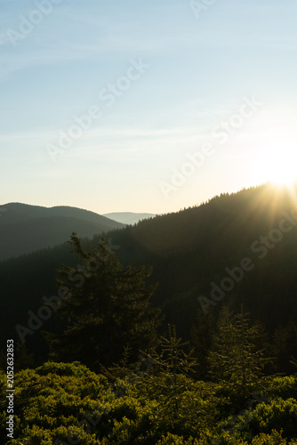  golden hour Sunrise In The Mountains With Silhouettes Of Peaks In The Rays Of The Setting Sun, Scenic Mountain Landscape In Yellow Red And Pink Hues, Evening Nature Background