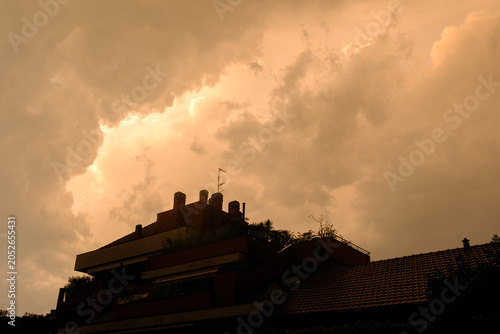 Stormy sky over buildings along via Piero della Francesca in Milan, Italy