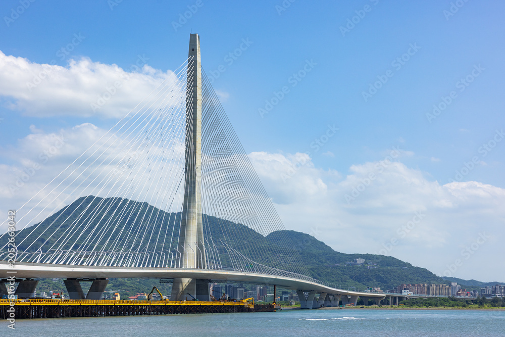 Fototapeta premium Danjiang Bridge in Tamsui Taiwan with blue sky
