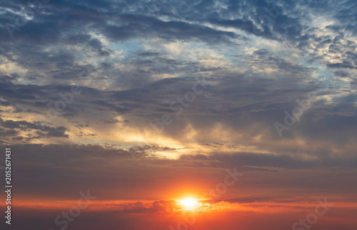 Sky replacement whispy gray, yellow and blue clouds with orange sunrise or sunset