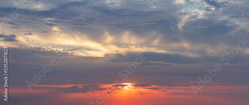 Sky replacement whispy gray and blue clouds with orange sunrise or sunset