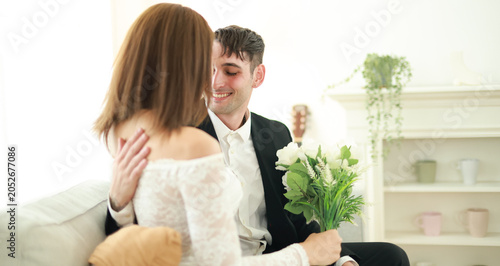 Fotografie Married couple sits affectionately expressing their love and goodwill towards each other transgender woman and handsome foreign man sit holding hands gently demonstrating equality