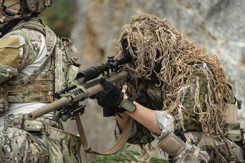 Canvas Print US Military marksman in camouflage ghillie suit conducting precision sniper oper