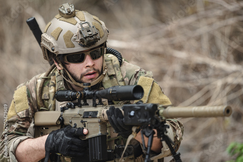 Cuadro en lienzo Military sniper aiming precision rifle during tactical reconnaissance mission in