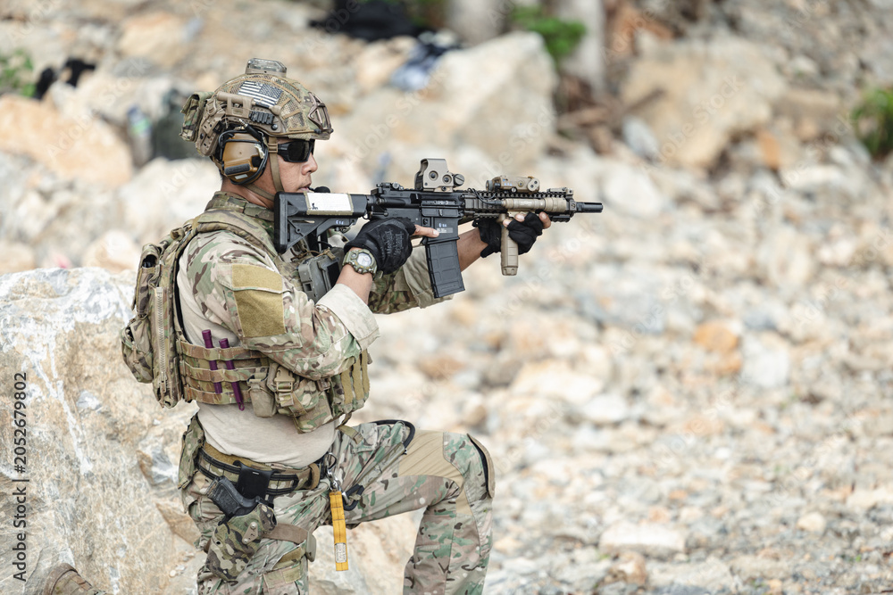 Fototapeta premium US Special forces soldiers engaged in combat operation, tactical military team in action