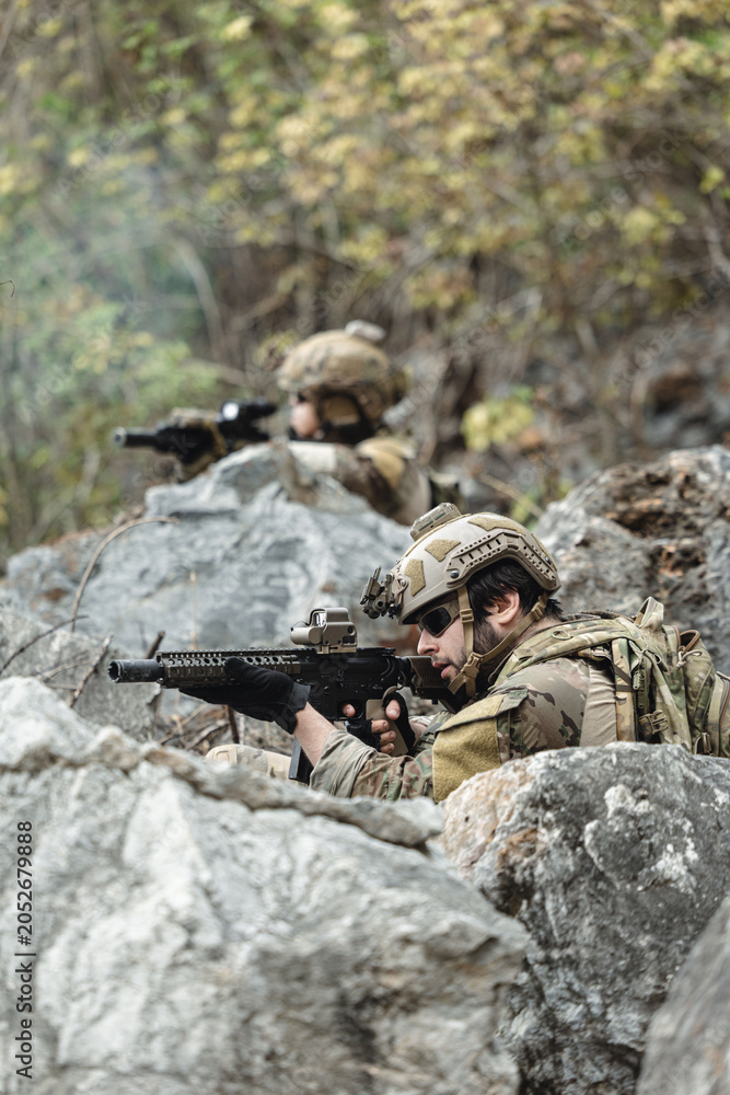 Fototapeta premium US Marine, Military Special forces soldier under heavy enemy fire intense battlefield engagement