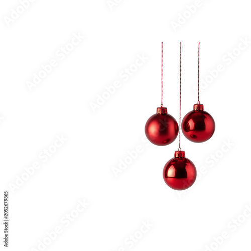 Three red Christmas baubles hanging on strings ornament isolated on a transparent background