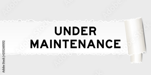 Foto Ripped gray paper background that have word under maintenance  under torn part