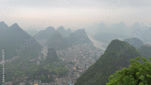 High angle panoramic view of Yangshuo town valley and Li river surrounded by majestic karst mountains in Guilin China