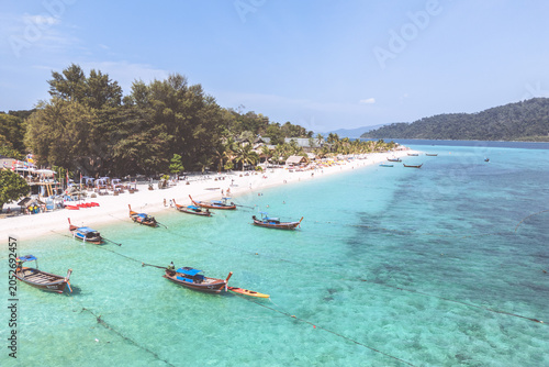 Aerial Drone View of Koh Lipe Island Beach with Turquoise Water and Long tail Boats, Thailand