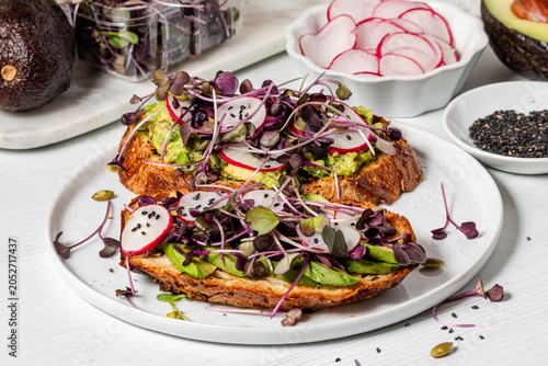 Servings of avocado toast topped with fresh organic ingredients.