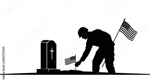 Photos Silhouette of a soldier placing flowers at a grave with american flags on memori