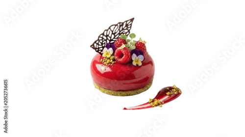 Glossy red mousse dessert with mirror glaze, edible flowers, gold accents and delicate chocolate garnish on biscuit base, showcasing modern pastry art on white background

