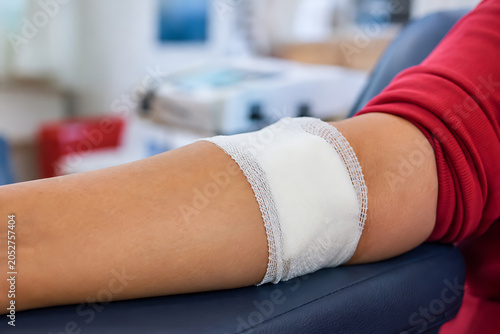 Donor Arm with Post Donation Bandage Resting in Clinical Blood Collection Chair