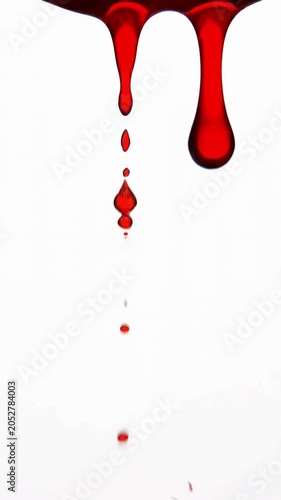 Red blood dripping down slowly on white background