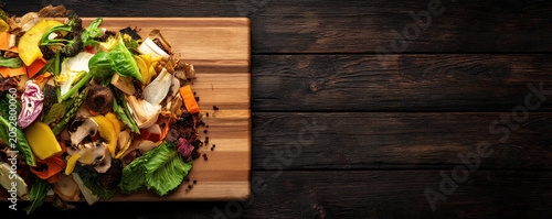 Food waste background cutting board vegetable peel compost rustic wood table colorful scrap organic recycling concept