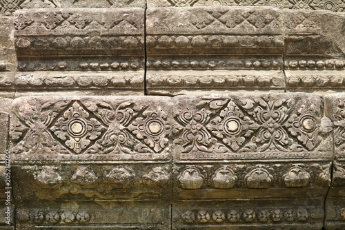 Front view of authentic ancient floral lozenge motifs carved on the sandstone base of Phimai main prang, Phimai historical park, Nakhon Ratchasima, Thailand