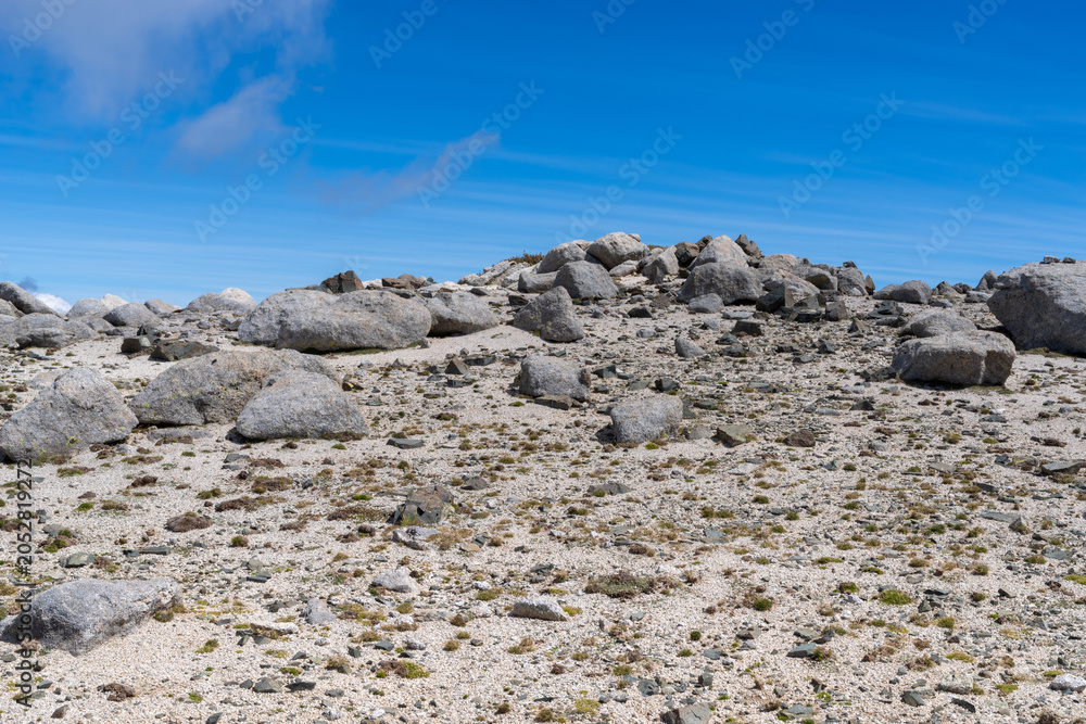 Fototapeta premium Rocky mountain terrain under clear blue sky