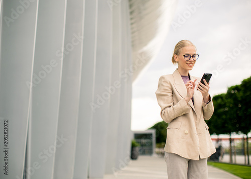 Woman using smartphone near...