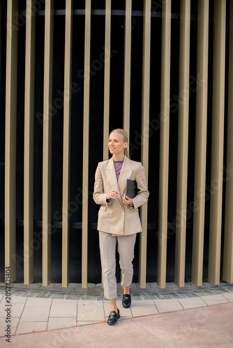 Businesswoman walks confide...