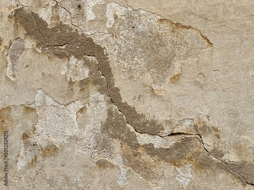 Weathered cracked concrete wall texture with peeling plaster
