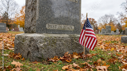 Gravestone with Flowers in Peaceful Cemetery Memorial Setting