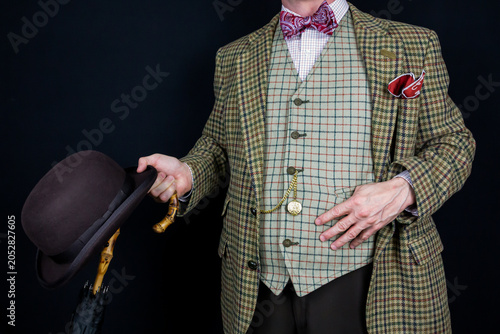 Fotografía British Gentleman in Tweed Suit Holding Bowler Hat and Umbrella