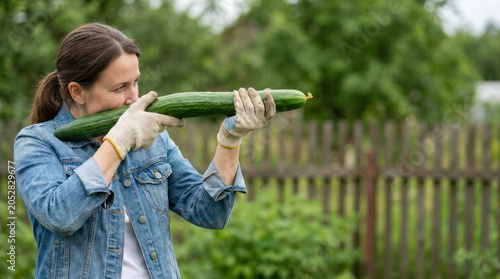 Playful Woman Pretending Cucumber Is a Rifle in Rural Field