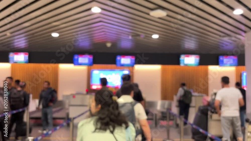 Passengers queue to board a plane at the airport terminal. Blur video.	