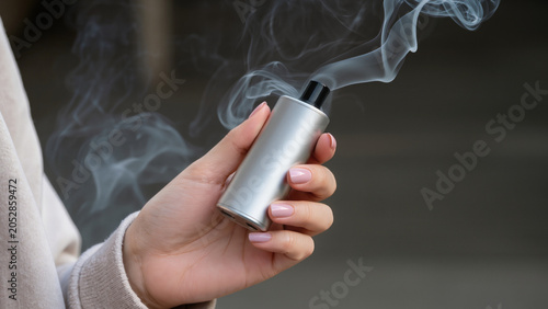 Photos Vaping device in hand, Person holding e-cigarette, Vaporizer smoking close up, F