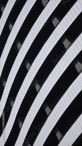 Abstract building facade with curving black and white stripes