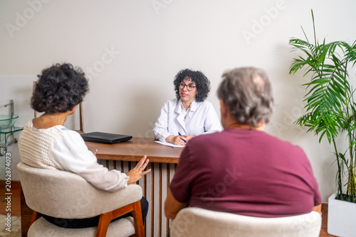 Doctor consulting senior couple about health prevention
