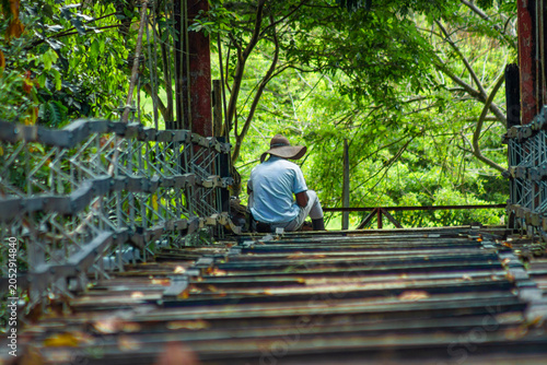 Person sitting on the bridge 