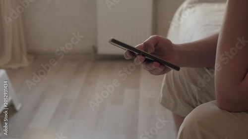 Tranquil person quietly browsing through messages. Composed person gently scrolling through messages before sleep. Relaxed individual peacefully exploring messages