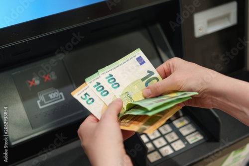 Quadro em tela Hands count euro banknotes withdrawn from an ATM during a cash transaction