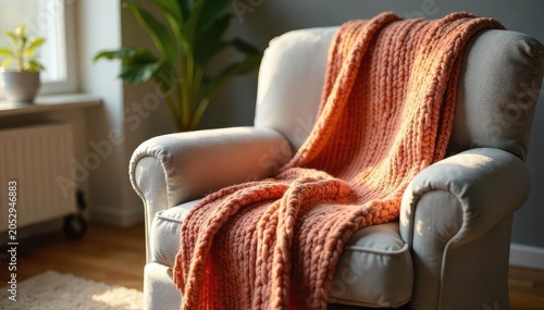 Cozy knit blanket draped over a plush armchair, inviting relaxation and a peaceful slumber Perfect for autumn or winter vibes, suggesting warmth and comfort , fabric, interior