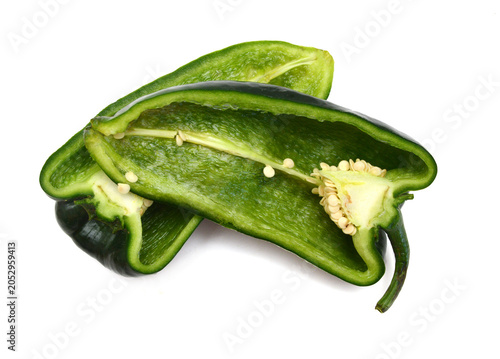 Stack dark green poblano peppers isolated on white