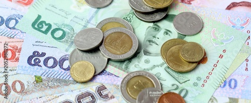 Vászonkép Thai baht money bills and coins on table