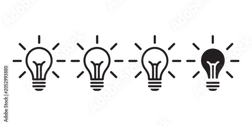 Four light bulbs with radiating lines in black and white on a white background idea innovation concept