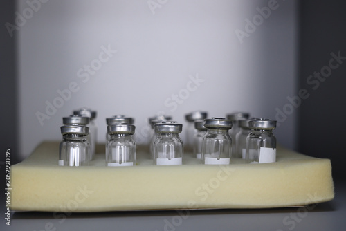 Empty pharmaceutical vials prepared for vaccine production, medical research and biotechnology laboratory testing. Concept of pharmaceutical manufacturing, healthcare innovation and drug development. 