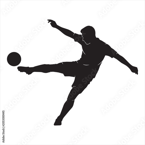 Silhouette of a soccer player kicking a ball