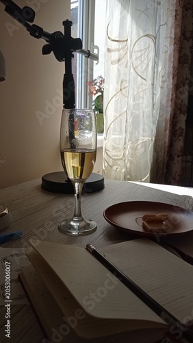 A glass of champagne on the table in a cozy interior.