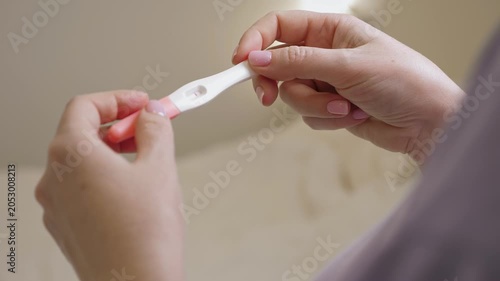 Woman holding in hands pregnancy test. Check quick pregnancy test kit