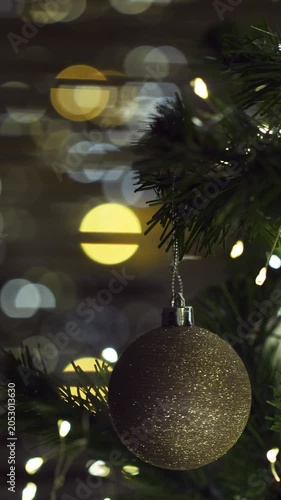 Christmas spruce tree decorated with balls and toys. New Year celebration. Closeup. Vertical footage