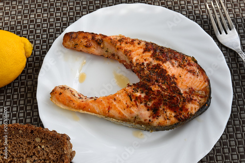 A piece of fried salmon on a plate