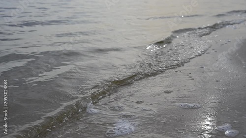 Static 4K video of a sandy beach coastline in real time with selective focus on fine sand texture. Perfect for travel and relaxing commercial use.