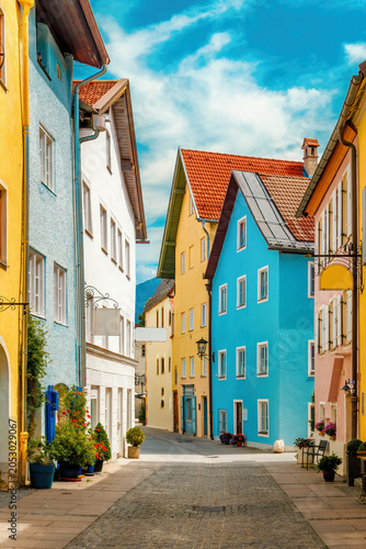 Colorful cobblestone Street in Fussen, Germany - a quaint Bavarian town scene.