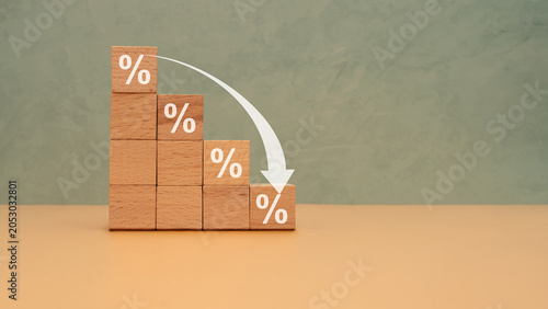 Interest Rates Decline Concept With Wooden Blocks Percentage Graph And Downward Arrow For Finance