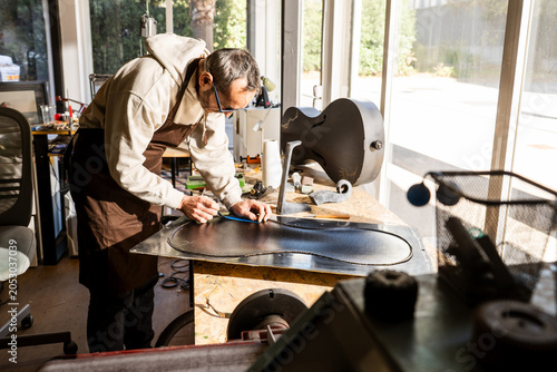 Luthier Works on Carbon Fiber Cello Mold in Workshop During Daytime